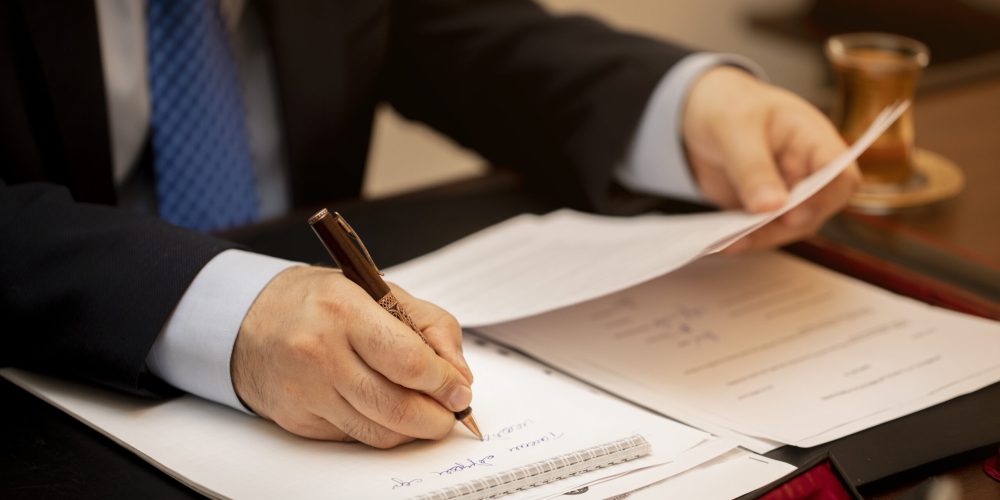 Businessman signing important contract papers. High quality photo